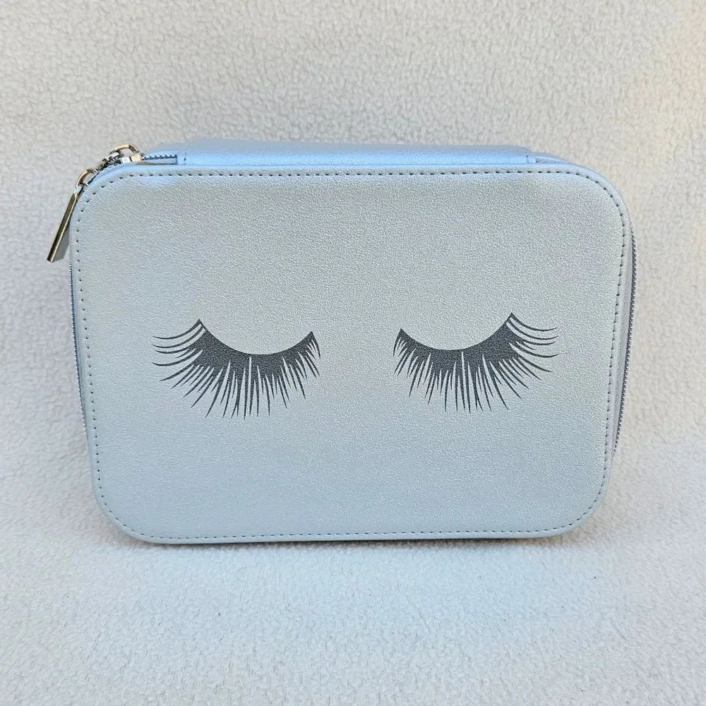 Neiman Marcus Silver Cosmetic Case with Eyelashes on the Front